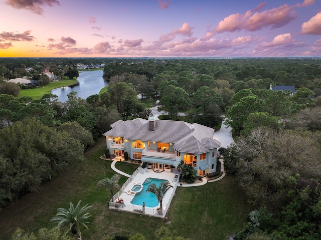 aerial view at dusk with a water view