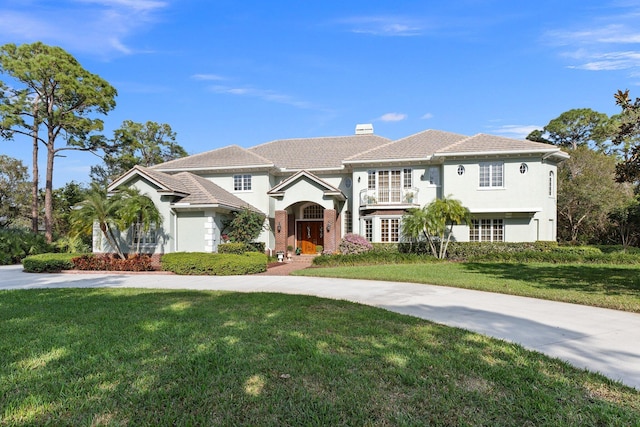 mediterranean / spanish house featuring a front yard