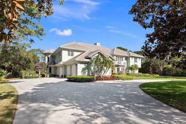 view of front of house with a garage and a front lawn