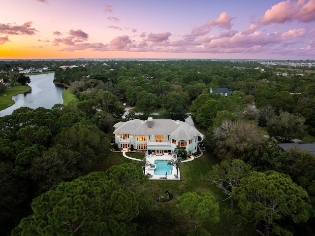 aerial view at dusk with a water view