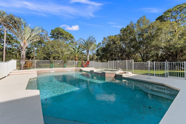 view of swimming pool with an in ground hot tub