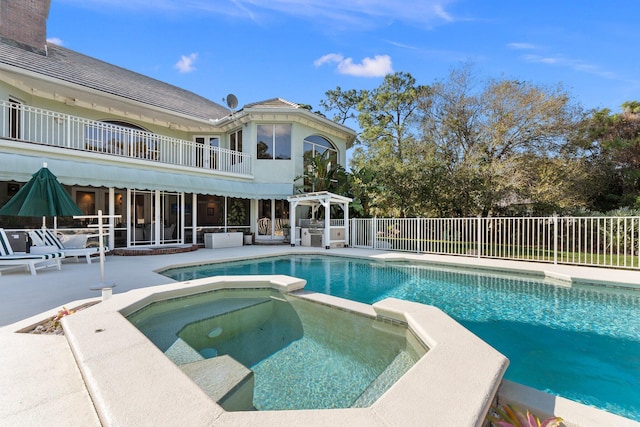 view of pool with an in ground hot tub and a patio area