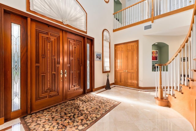 entryway featuring a towering ceiling