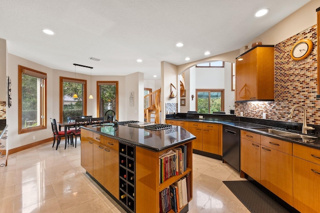 kitchen with dishwasher, a center island with sink, plenty of natural light, and sink