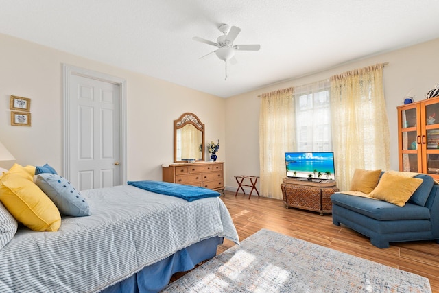 bedroom with ceiling fan and light wood-type flooring