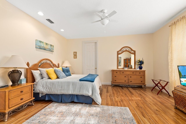 bedroom with light hardwood / wood-style floors and ceiling fan