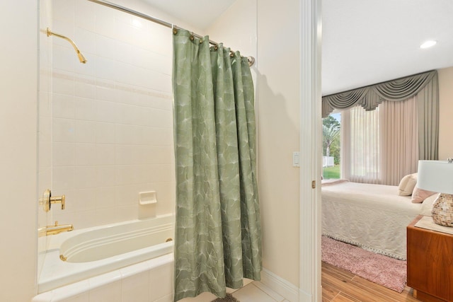 bathroom featuring shower / bath combination with curtain and hardwood / wood-style flooring