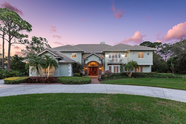 mediterranean / spanish-style home featuring a yard