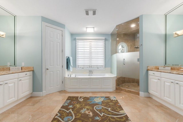 bathroom with tile patterned floors, vanity, and separate shower and tub