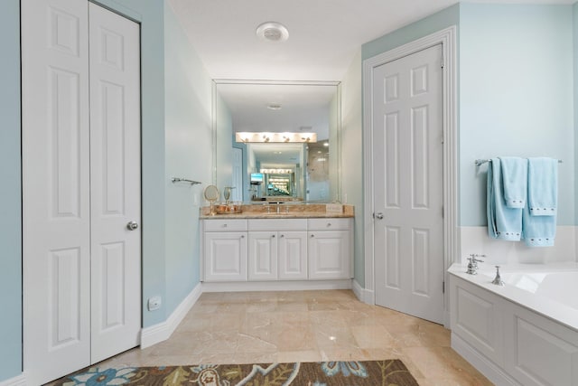 bathroom featuring vanity, tile patterned floors, and a bathing tub