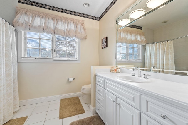 bathroom with toilet, vanity, tile patterned floors, and plenty of natural light