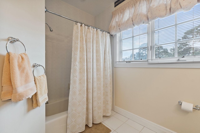 bathroom featuring tile patterned flooring and shower / tub combo with curtain