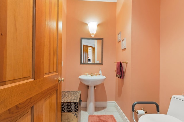 bathroom featuring tile patterned floors and toilet