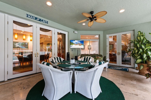 sunroom featuring french doors and ceiling fan