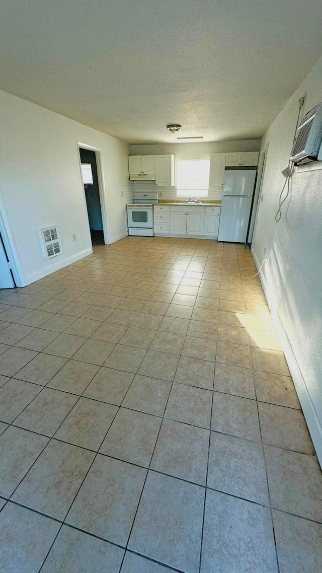 unfurnished living room with light tile patterned flooring