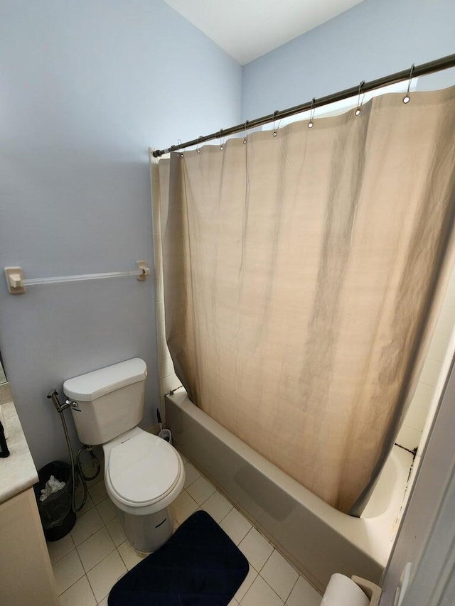 bathroom with tile patterned flooring, shower / bath combo, and toilet