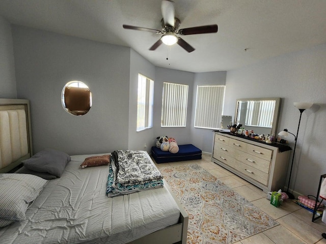 bedroom with ceiling fan and light tile patterned floors