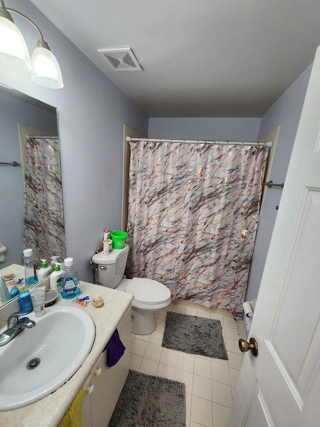 bathroom with tile patterned flooring, vanity, a shower with shower curtain, and toilet