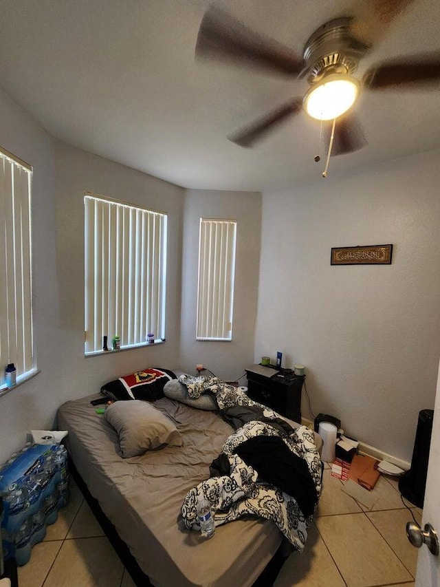 tiled bedroom with ceiling fan