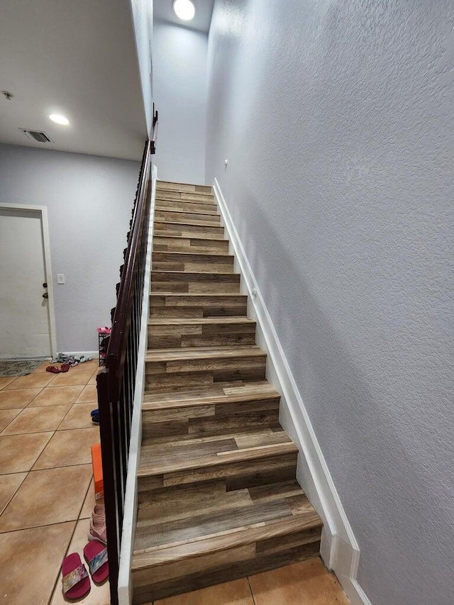 staircase with tile patterned floors