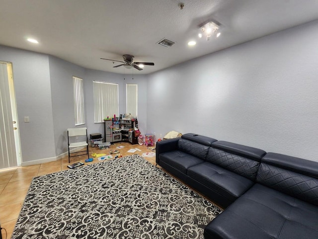 tiled living room with ceiling fan