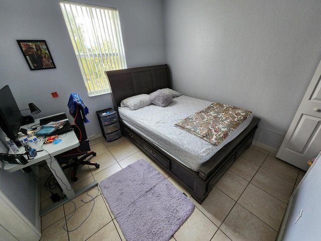 bedroom featuring light tile patterned floors