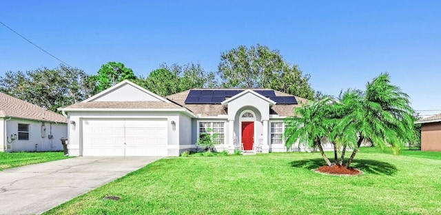 ranch-style home with solar panels, a front yard, and a garage