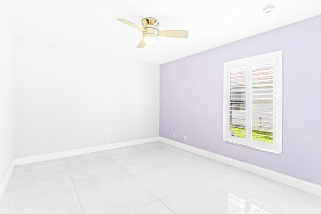 empty room featuring ceiling fan and light tile patterned floors