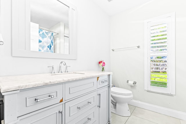 bathroom featuring toilet, vanity, tile patterned floors, and a shower with curtain