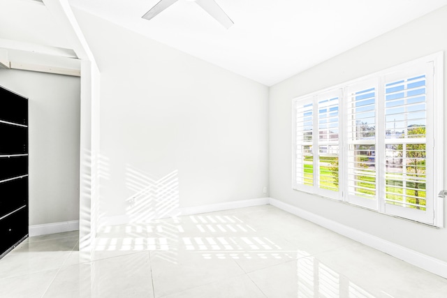 empty room featuring ceiling fan and light tile patterned floors