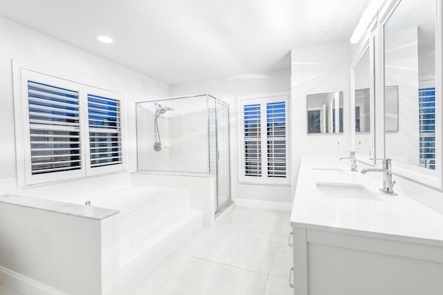 bathroom with separate shower and tub, vanity, and tile patterned floors