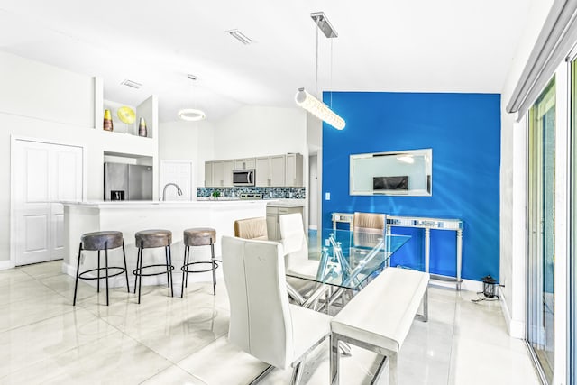 dining room with lofted ceiling and sink