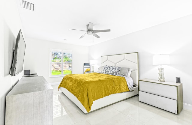 tiled bedroom with ceiling fan