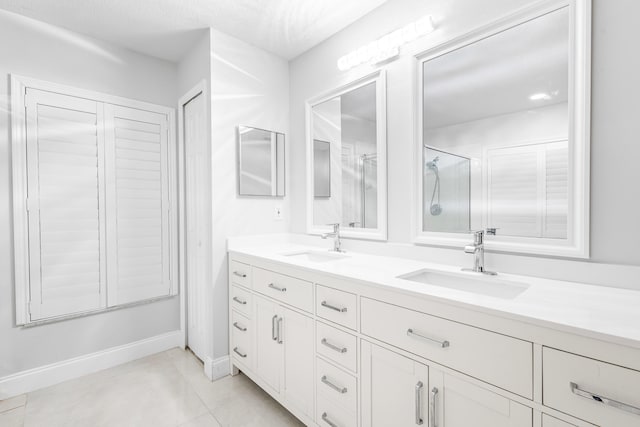 bathroom with vanity, tile patterned flooring, and a shower with shower door