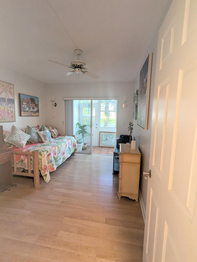 bedroom featuring access to exterior, wood-type flooring, and ceiling fan