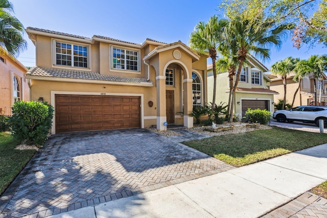 mediterranean / spanish house with a garage