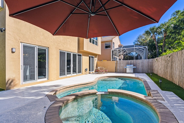 view of swimming pool featuring a grill, an in ground hot tub, and a patio area