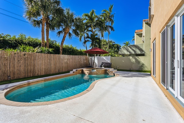 view of swimming pool with an in ground hot tub and a patio