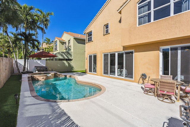 view of pool featuring a patio area and an in ground hot tub