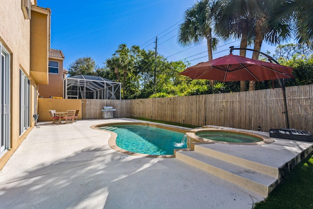 view of swimming pool with an in ground hot tub and a patio