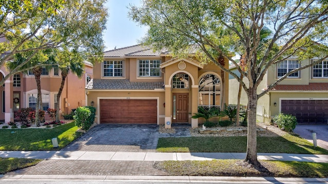 mediterranean / spanish-style house with a garage