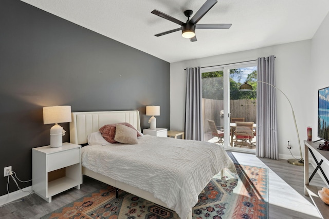 bedroom with hardwood / wood-style floors, ceiling fan, and access to outside