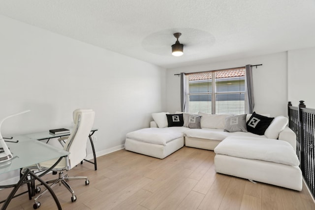 office area featuring ceiling fan, a textured ceiling, and light wood-type flooring