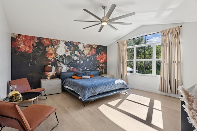 bedroom featuring light hardwood / wood-style floors, ceiling fan, and lofted ceiling