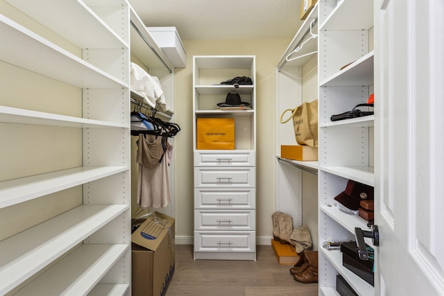 walk in closet featuring hardwood / wood-style flooring