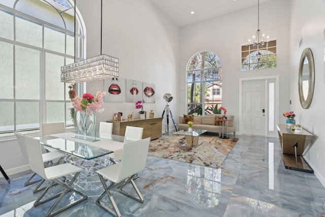 interior space featuring a towering ceiling and a chandelier