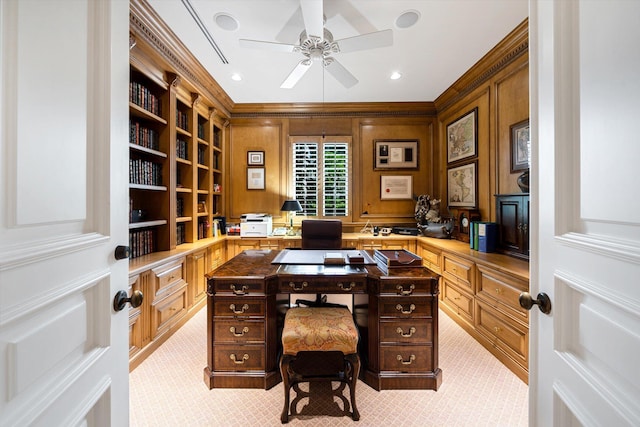 carpeted home office featuring ceiling fan and ornamental molding