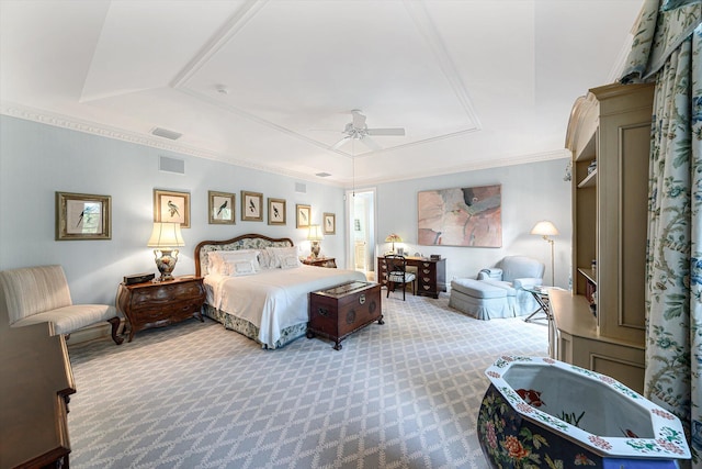 bedroom featuring light carpet, a tray ceiling, ceiling fan, and crown molding