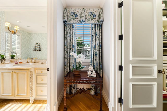 bathroom with hardwood / wood-style flooring, crown molding, and a wealth of natural light