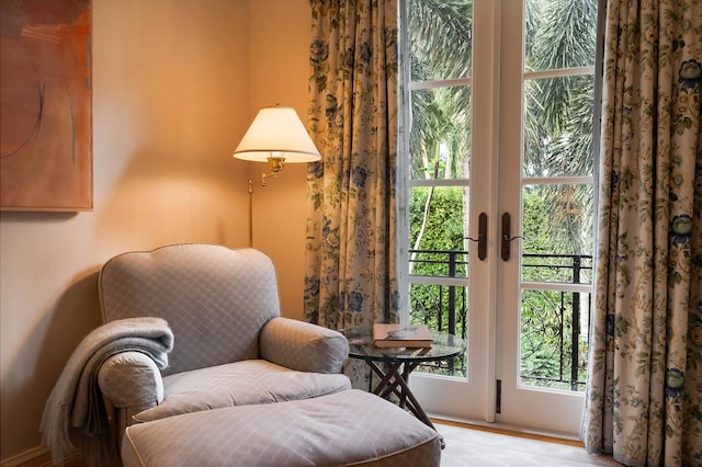 sitting room with french doors and light hardwood / wood-style flooring